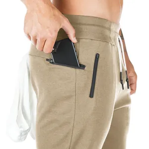 Detail view of men's athletic joggers showing zippered pocket and fabric texture