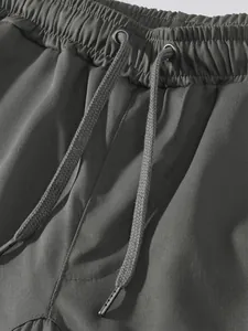 Close-up of elastic waistband and drawstring on men's grey casual cargo pants