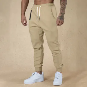 Close-up of men's beige drawstring joggers paired with stylish and clean white sneakers