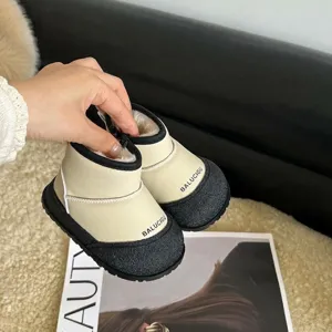 Detailed shot of beige and black toddler winter snow boots with thick plush lining