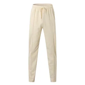 Close-up detail of off-white men's joggers featuring elastic drawstring waist and texture