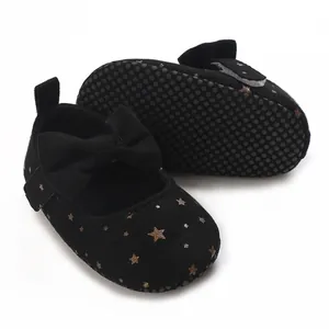 Macro detail of black baby girl Mary Jane shoes with gold stars and anti-slip sole
