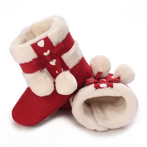 Detailed view of warm red baby winter boots with soft white fleece lining