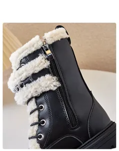 Close-up detail of black children's Martin boots with warm lamb wool lining and side zipper