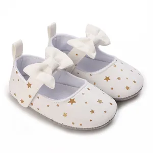 Elegant white baby princess walking shoes with gold star patterns and a large bow