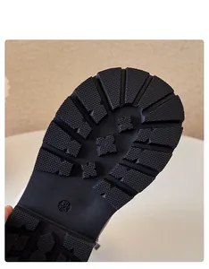 Detailed view of the durable anti-slip rubber sole texture on children's Martin boots