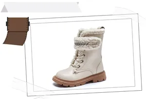 Side view detail of cream kids' winter boots with cozy fleece trim and silver chain.