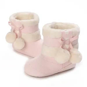 Pink winter baby snow boots with warm plush lining and cute pom-poms bow detail.