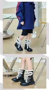 Detailed view of children's fleece-lined black boots with sheep curly hair trim
