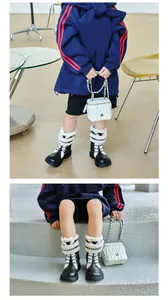 Detail view of children's warm Martin boots with white faux lamb wool lining.
