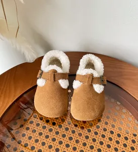 Cozy children's shearling-lined winter clogs with warm fleece interior and adjustable strap
