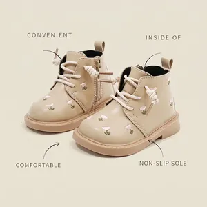 Beige toddler girl Martin boots with cute embroidered flowers and side zipper closure