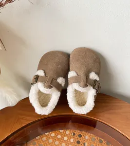 Detailed close-up of warm brown suede children's winter clogs with soft fleece lining