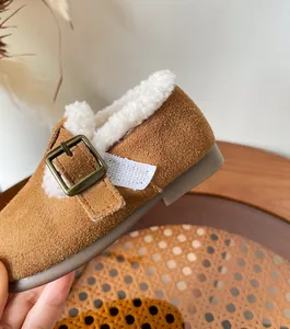 Close-up of warm faux fur lining and suede texture on children's winter shoes