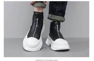Detailed view of chunky black and white platform boots with front zipper design.