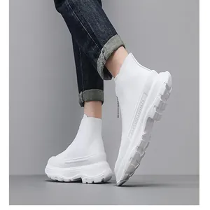Detail of white trendy thick-sole leather boots with front zipper and fashion sports text.