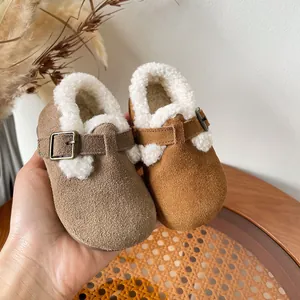 Cozy fleece-lined children's winter shoes in brown and khaki suede with buckle straps.