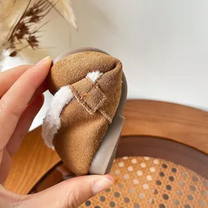 Flexible brown suede children's winter shoes with warm white fleece lining for toddlers.