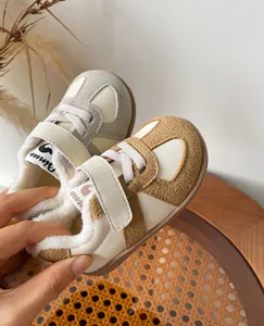 Detailed view of children's winter sneakers featuring warm fleece lining and soft suede texture