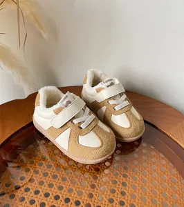 Cozy cream and tan children winter sneakers with warm fleece lining and Velcro strap closure.
