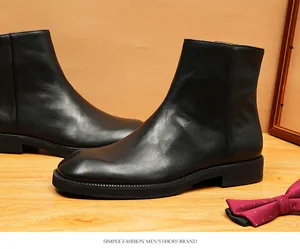 Macro view of men's premium black genuine leather square-toe Chelsea boots with sleek finish