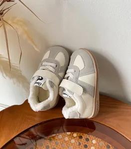 Close-up of cozy fleece-lined winter leisure sneakers for toddlers in grey and cream