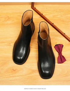 High-quality detailed top view of men's square-toe leather Chelsea boots in black.