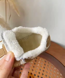 Close-up detail showing the soft and warm white fleece lining of children's winter shoes