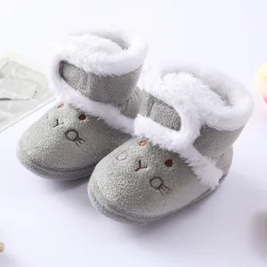 Close-up of grey baby winter boots with soft white faux fur lining and cute rabbit embroidery.