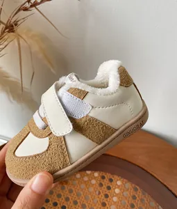 Close-up of warm winter baby sneakers with soft faux fur lining and velcro strap