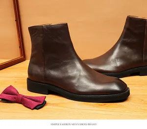 Detailed shot of premium brown leather Chelsea boots with square toe and stitch finish