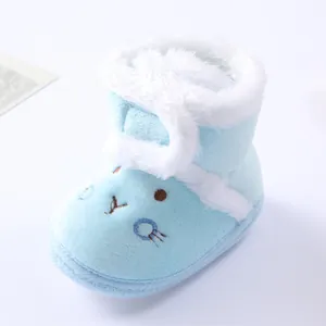 Close-up view of soft light blue baby winter booties with fluffy white faux-fur trim