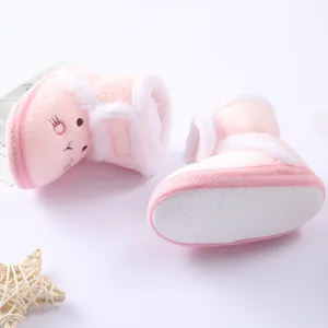 Close-up of pink plush baby boots featuring cute embroidery and white non-slip dotted sole