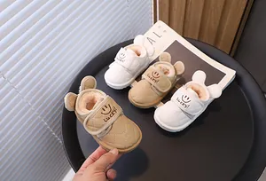 Close-up detail of cute rabbit-ear baby winter snow boots with warm fleece lining.