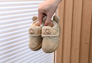 Detail of beige toddler winter snow boots with plush lining and Lucky embroidery