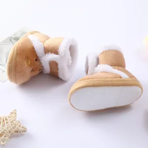 Detail of soft-soled baby winter boots showing anti-slip texture and plush lining.