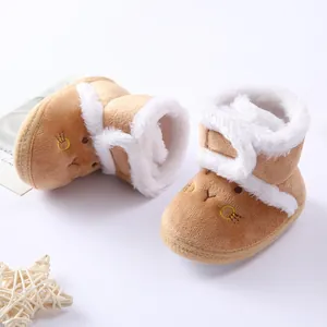 Close-up of soft khaki baby winter boots with white faux fur lining and animal embroidery