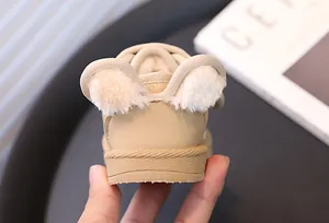 Detailed view of beige toddler snow boots featuring cute fluffy bear ears on the heel