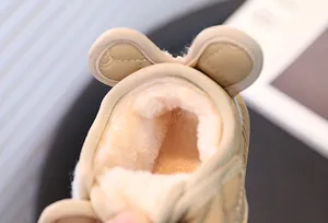 Close-up detail of the warm and thick plush lining inside khaki kids winter snow boots.