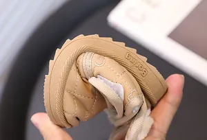 Close-up showing the high flexibility of the soft sole on khaki toddler winter snow boots
