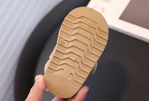 Close-up of anti-slip rubber sole for children's winter snow boots showing size mark.