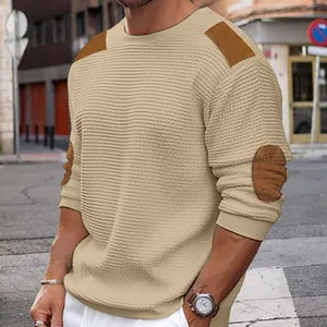 Detail view of men's khaki knit sweater featuring brown shoulder and elbow patches