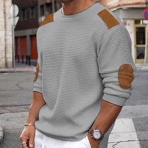 Close-up of men's slim fit grey knitted sweater with brown shoulder and elbow patches
