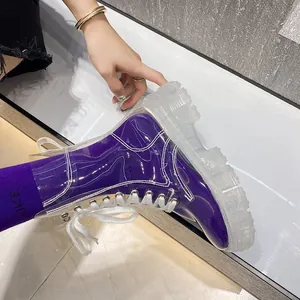 Detailed shot of trendy purple translucent Martin boots with clear chunky platform sole