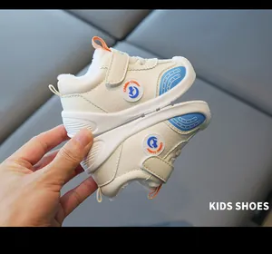 Detail of warm fleece-lined toddler shoes with waterproof leather in white and blue.