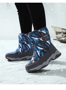 High-top children's snow boots with blue camouflage pattern in snowy setting