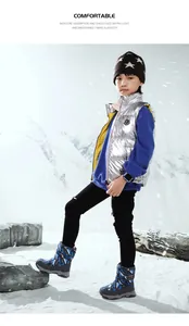 Full body view of a child wearing blue camouflage snow boots in a snowy mountain