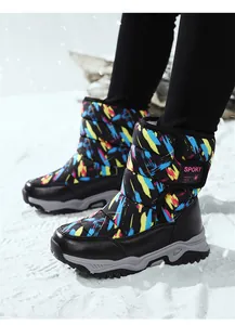 Detail of colorful graffiti print children's snow boots on snow background