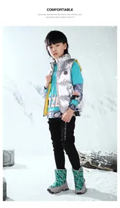 Boy wearing patterned green winter snow boots in a snowy mountain scene outdoor setting