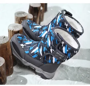 Detail of kids high-top snow boots with blue camo pattern and thick white faux fur lining.